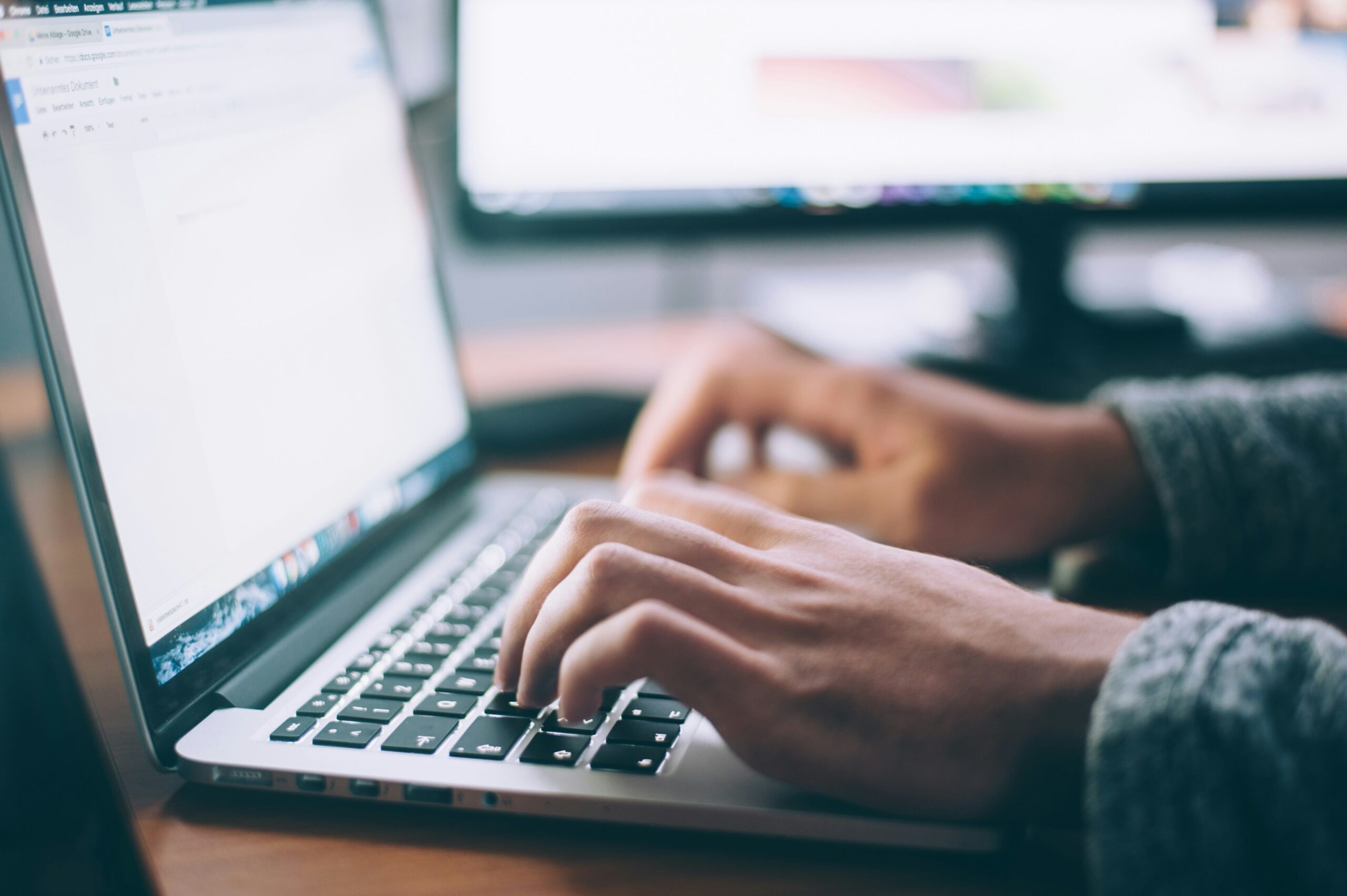 web designer typing on laptop