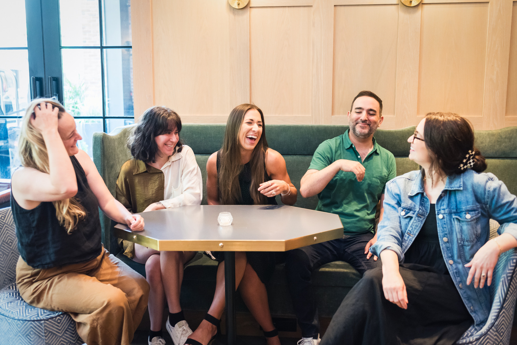 Push10 design team sitting around a table laughing