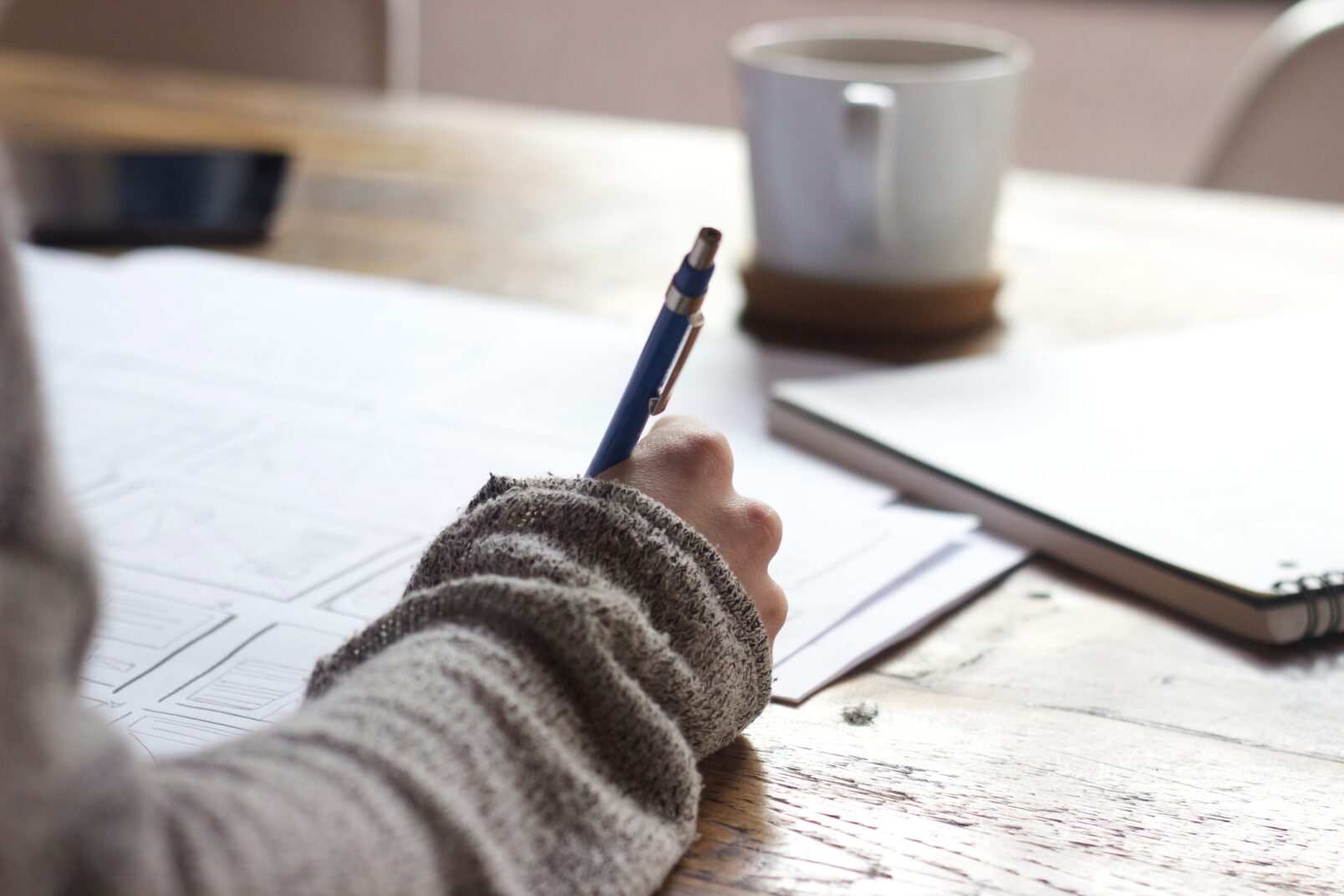 Person writing at a desk