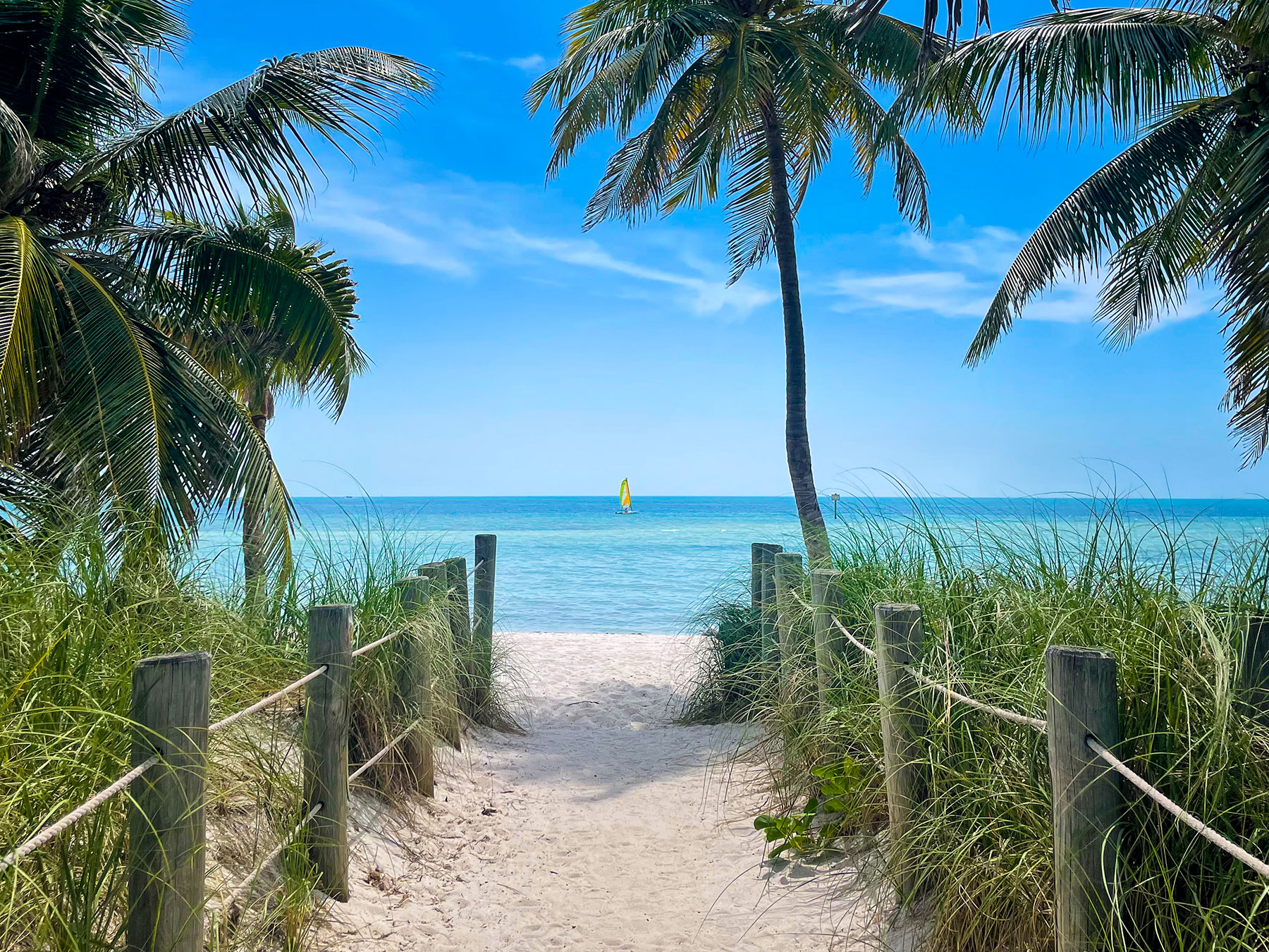 Smathers beach Key West with sail boat photographed by Greg Henry