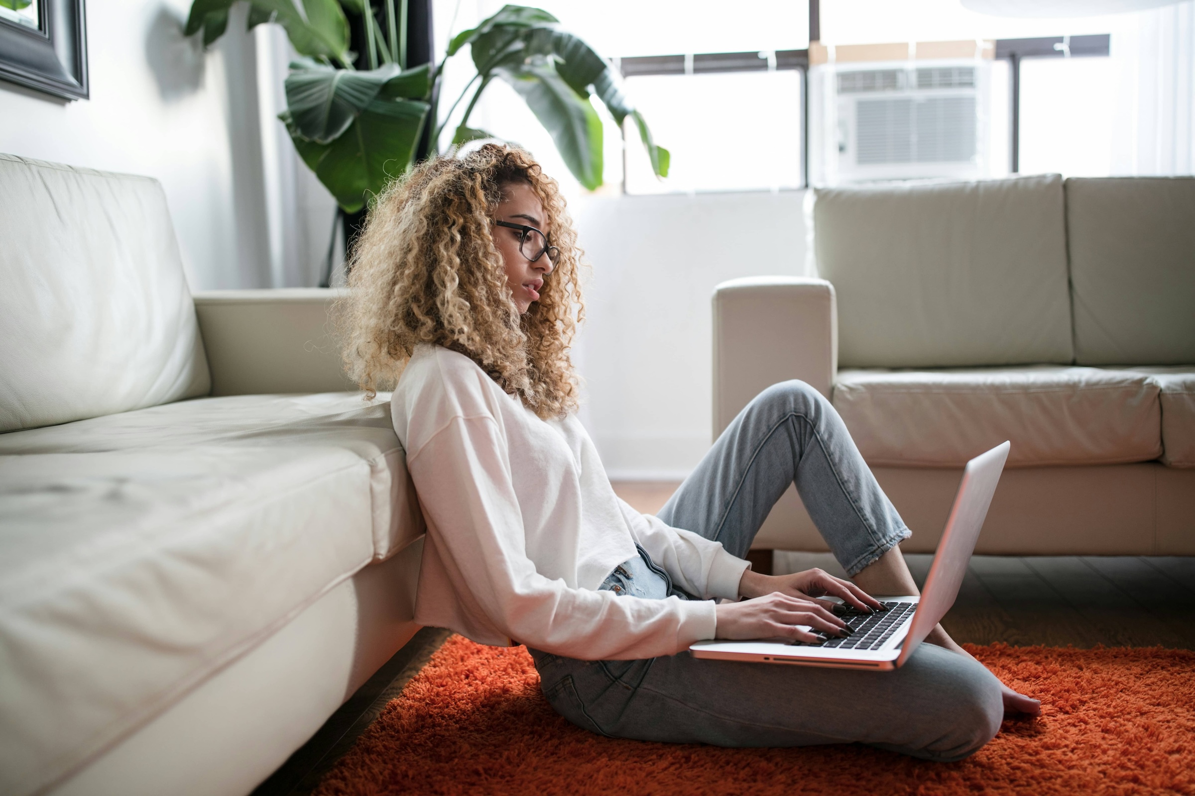 Woman browsing computer on the floor