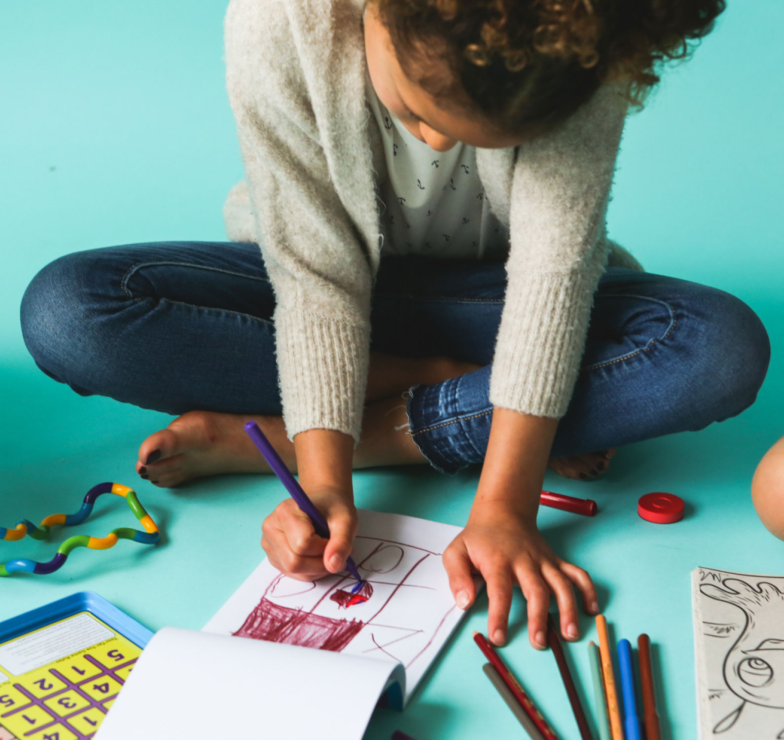 A kid drawing on a mint background