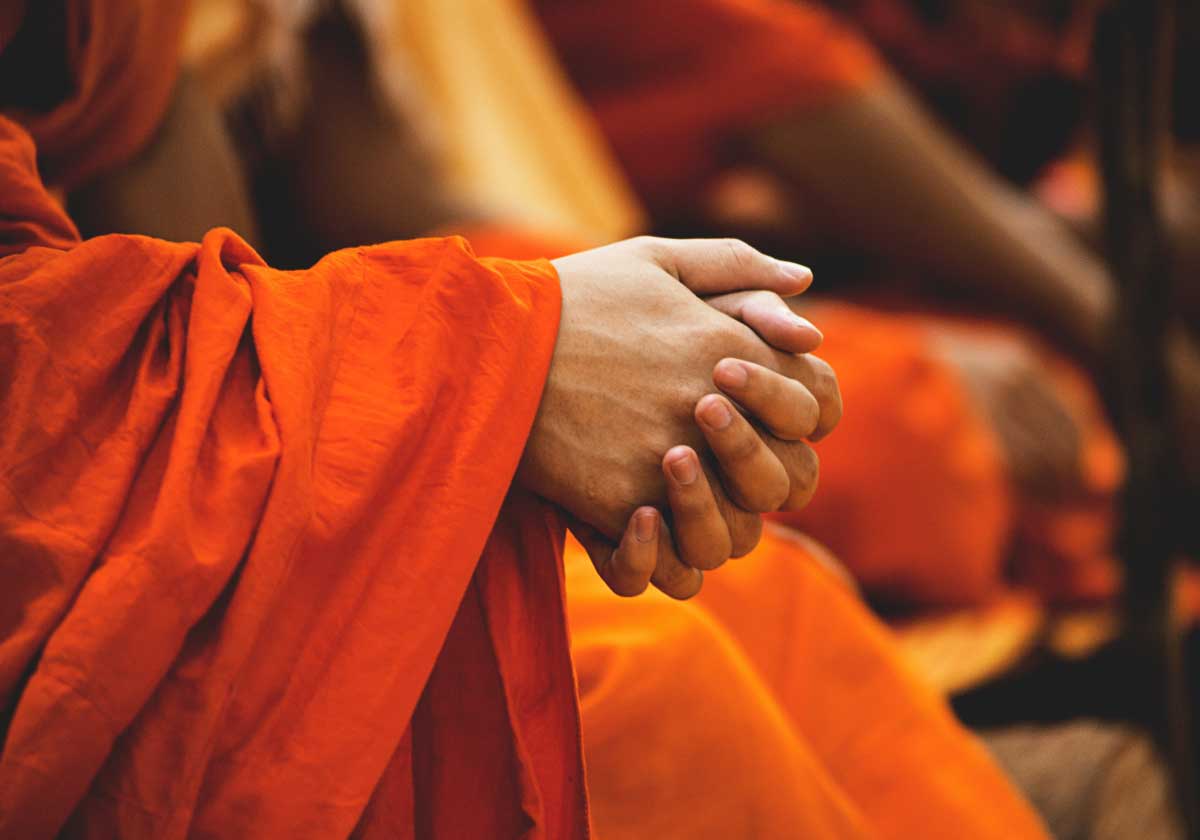 The clasped hands of a monk.