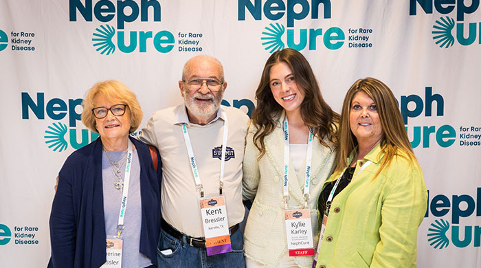 NephCure community poses in front of step-and-repeat logo wall at event